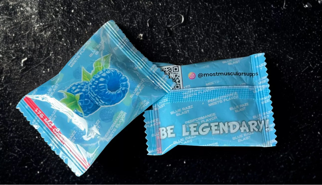 Close-up of a single serving packet of Blue Razz Blast flavored pre-workout gummies from Most Muscular, showing the flavor graphics and the "Be Legendary!" slogan.