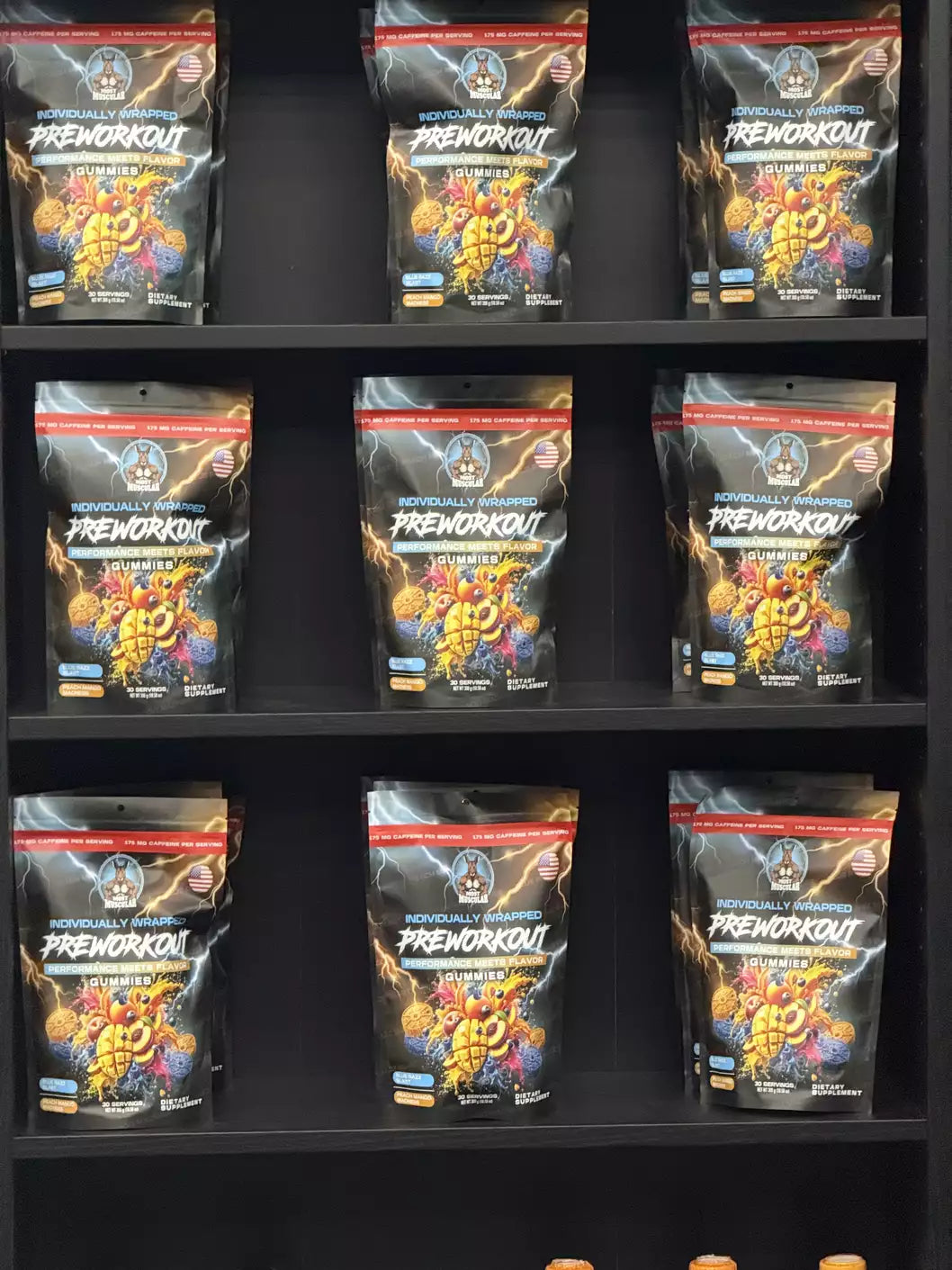 A retail shelf display featuring multiple bags of Most Muscular individually wrapped pre-workout gummies, showing the product ready for sale.